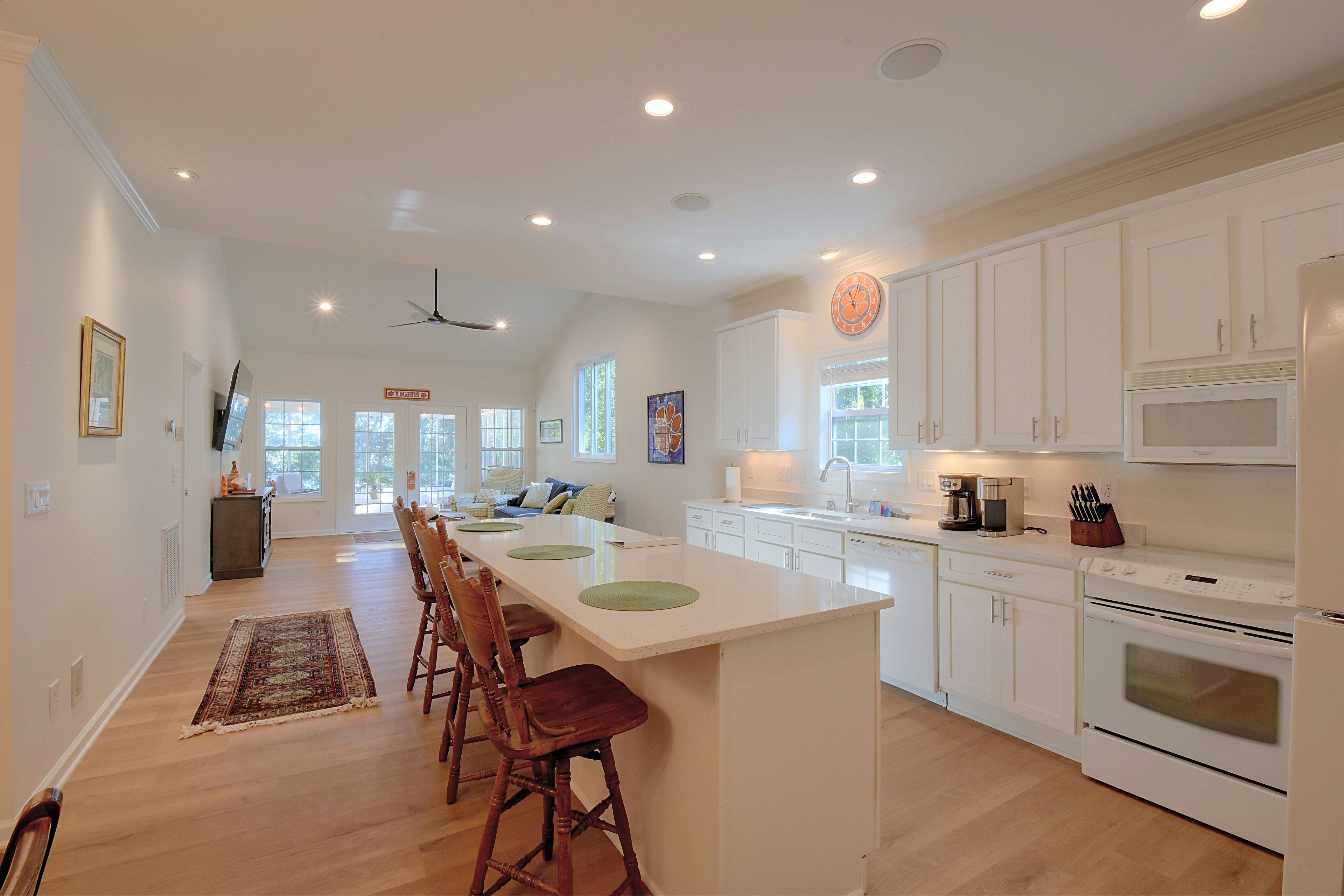 Kitchen island counter with wooden barstools.