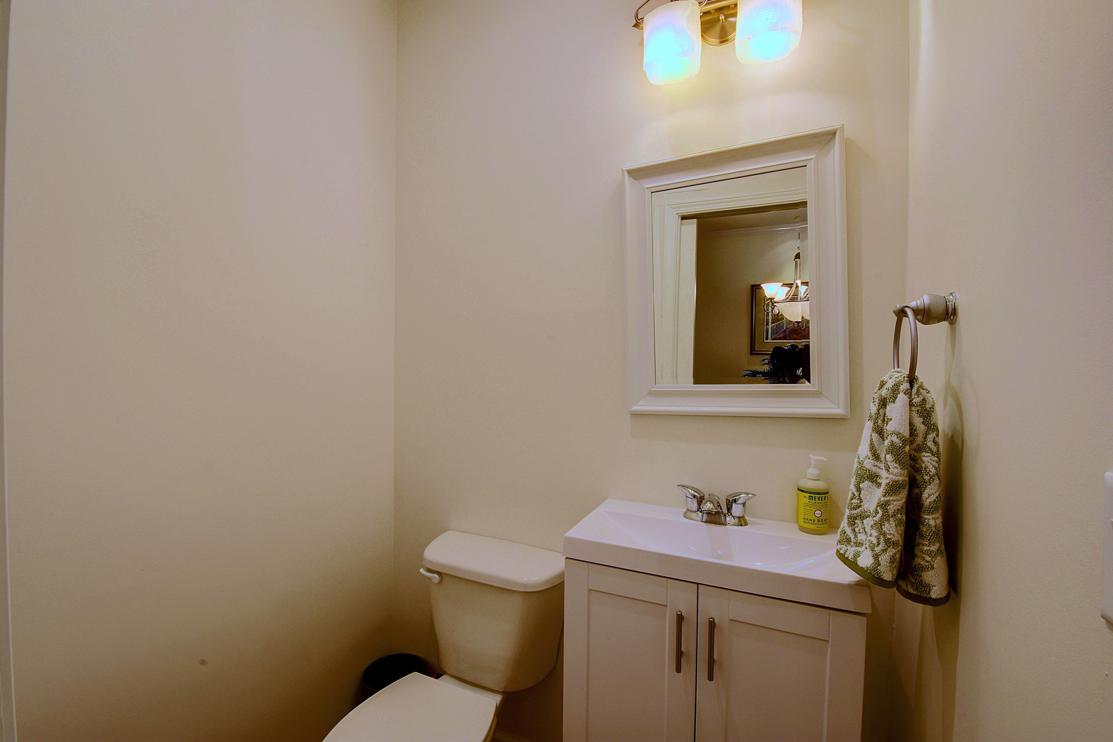 Main-level half bathroom with vanity and toilet.