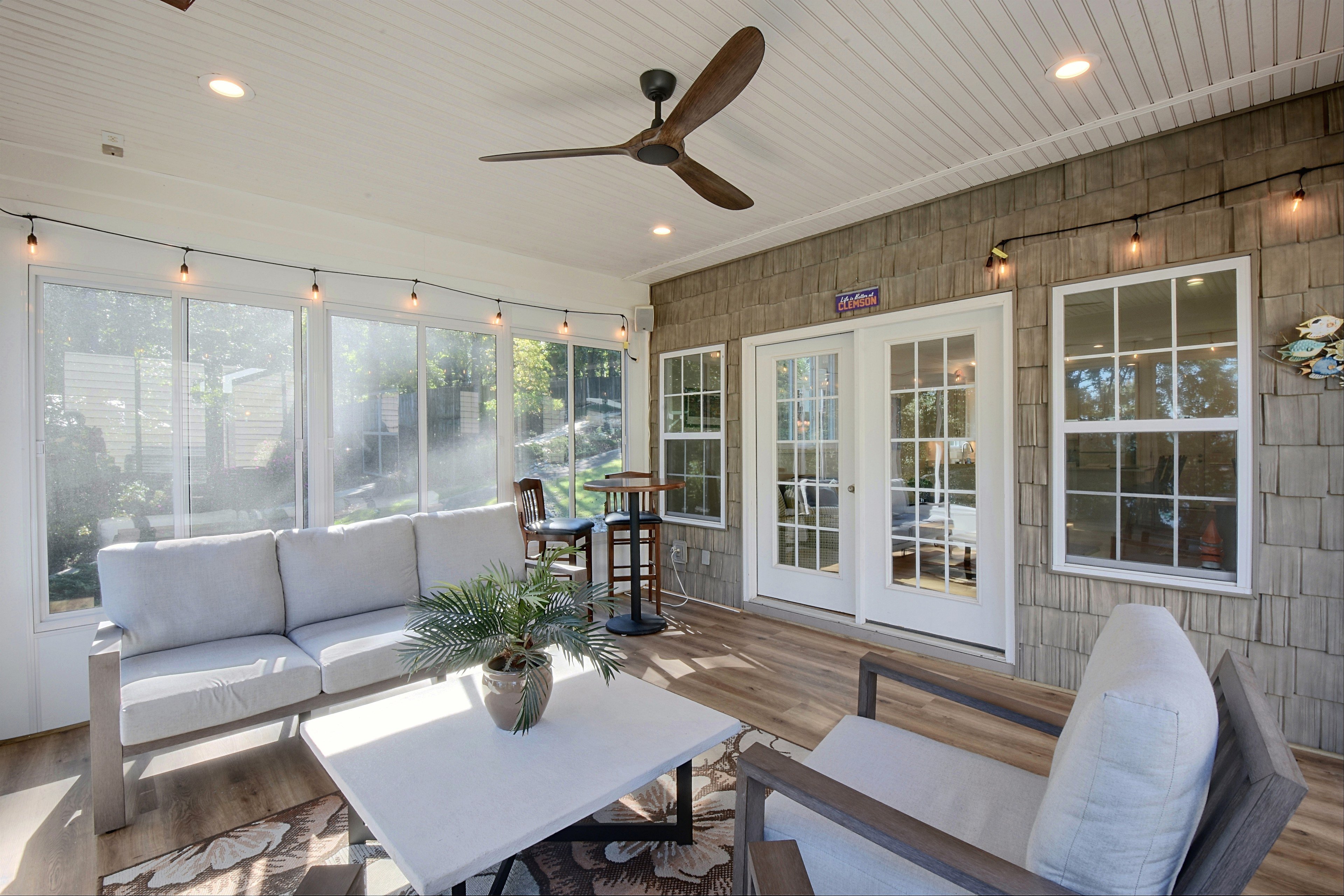 Alternate view of sunroom seating with wicker armchairs.