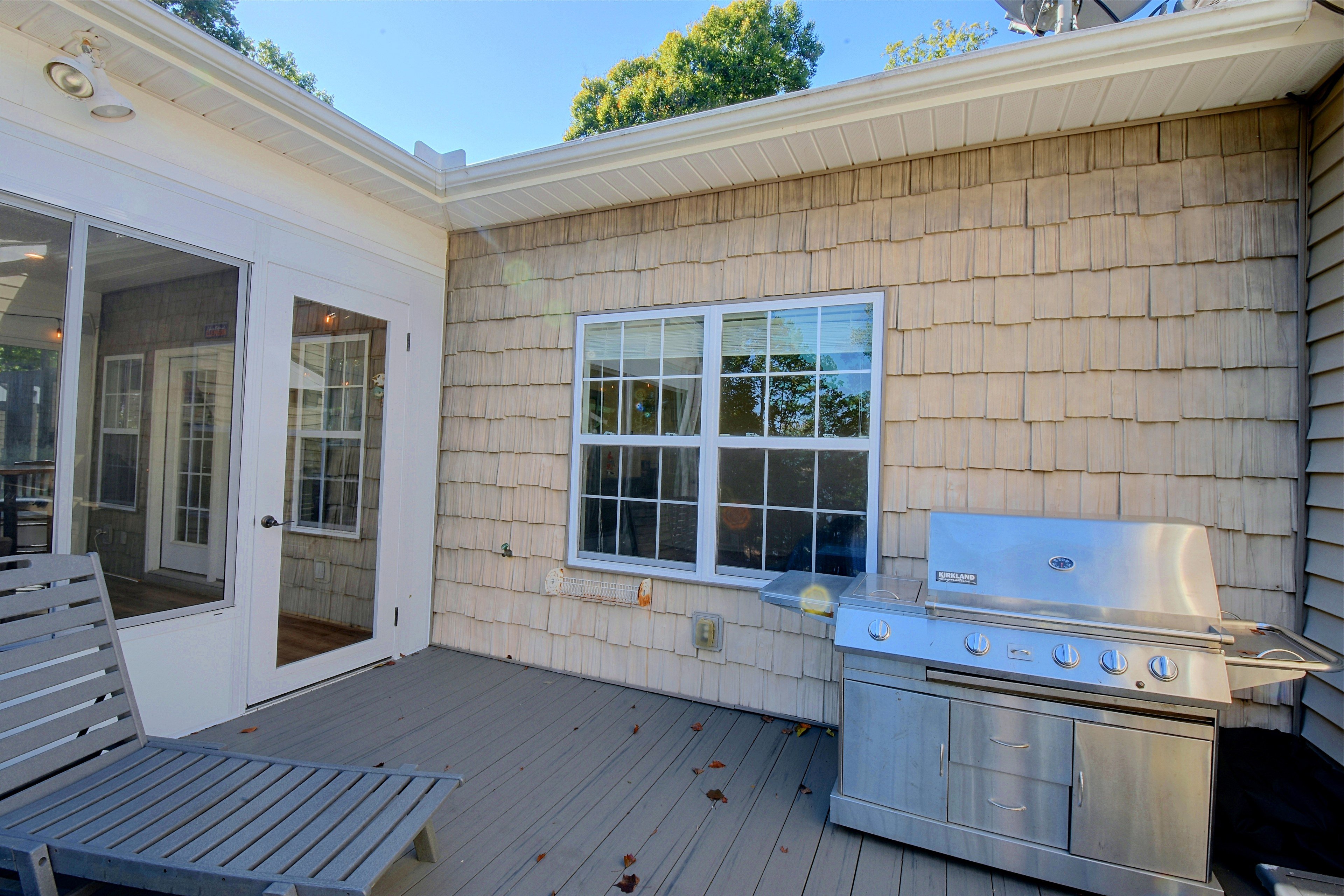 Stainless steel gas grill situated on the upper deck.