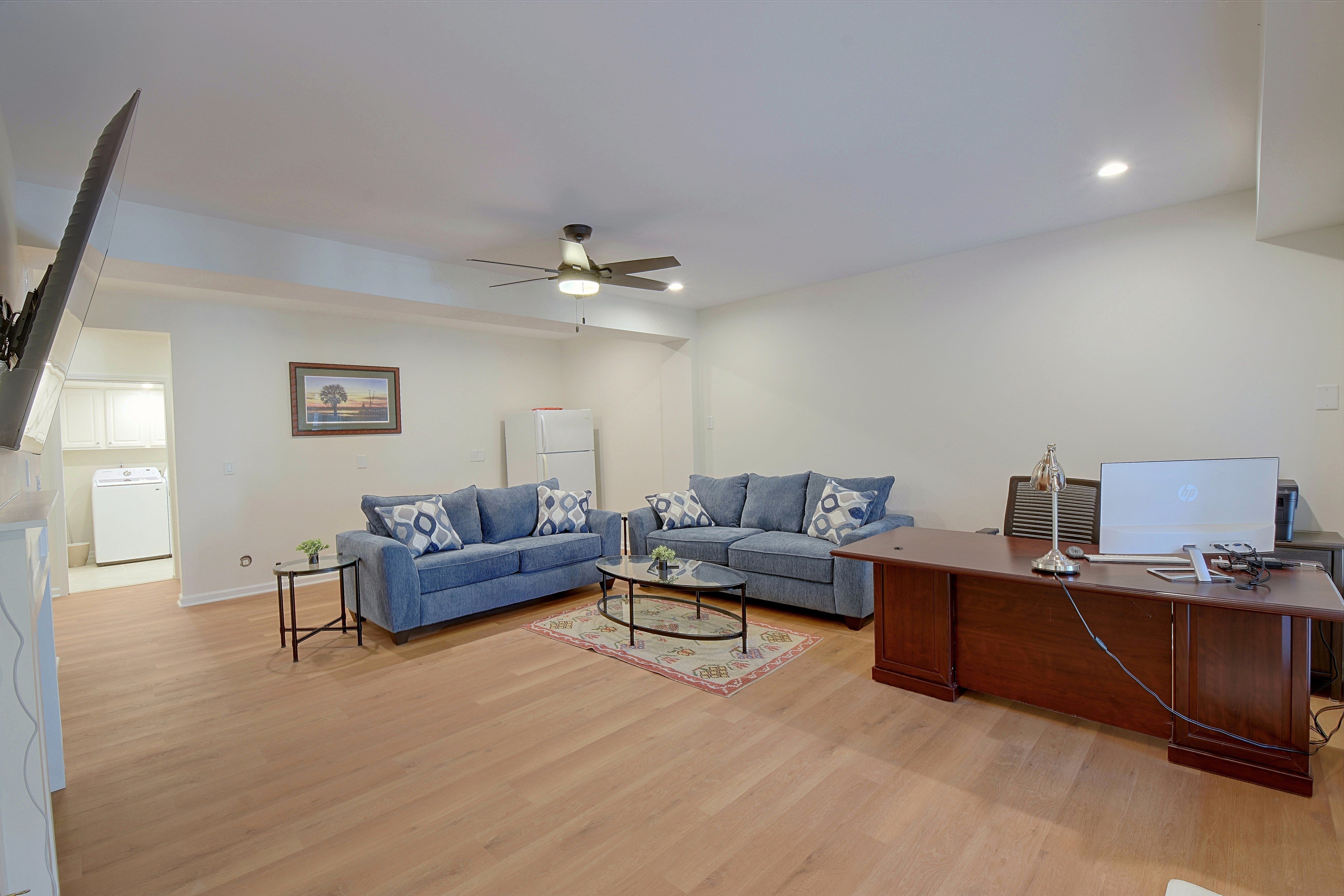 Lower-level living room facing sectional couch and coffee table.