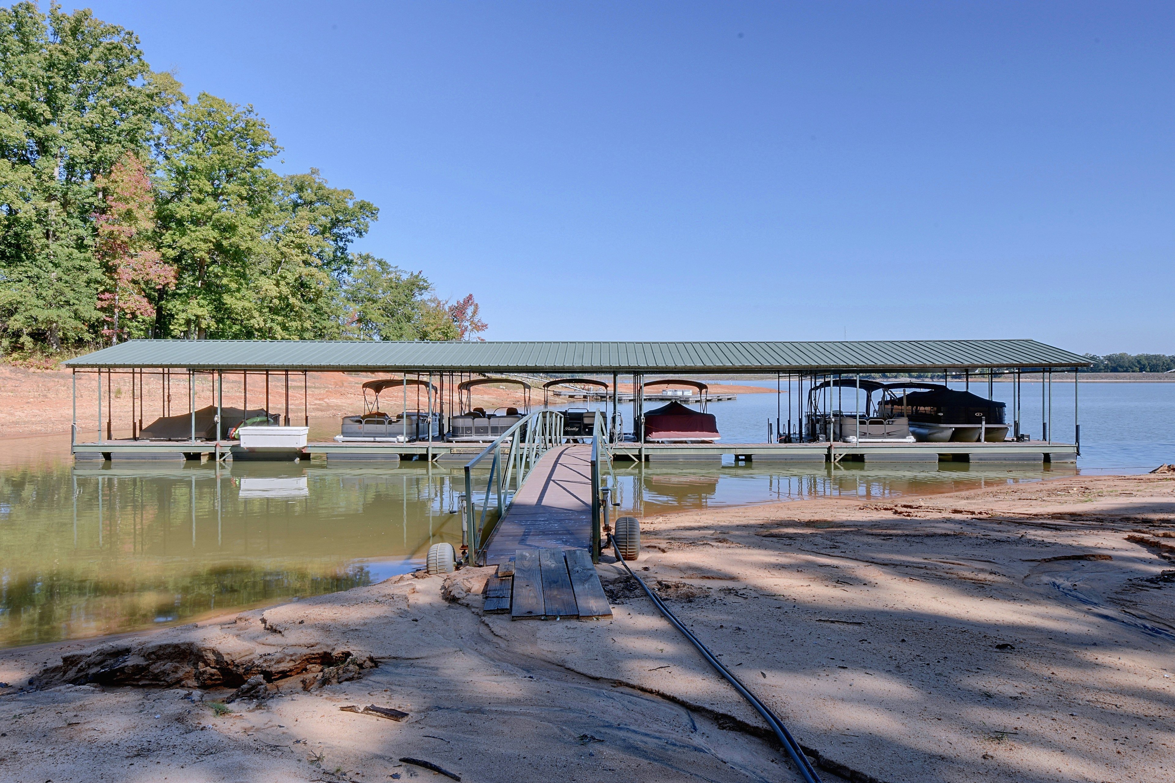 Covered boat dock structure on the lake shore.