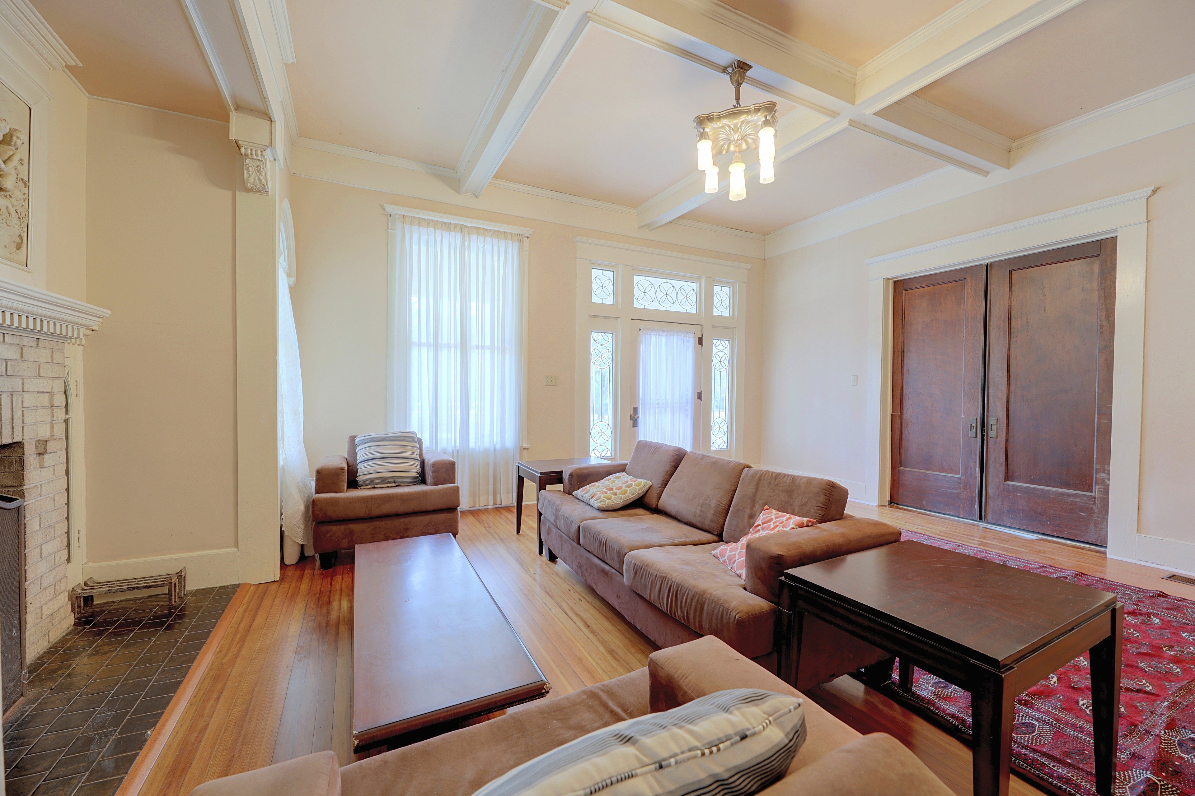 Comfortable seating area in the living room with double doors leading to an adjacent room.
