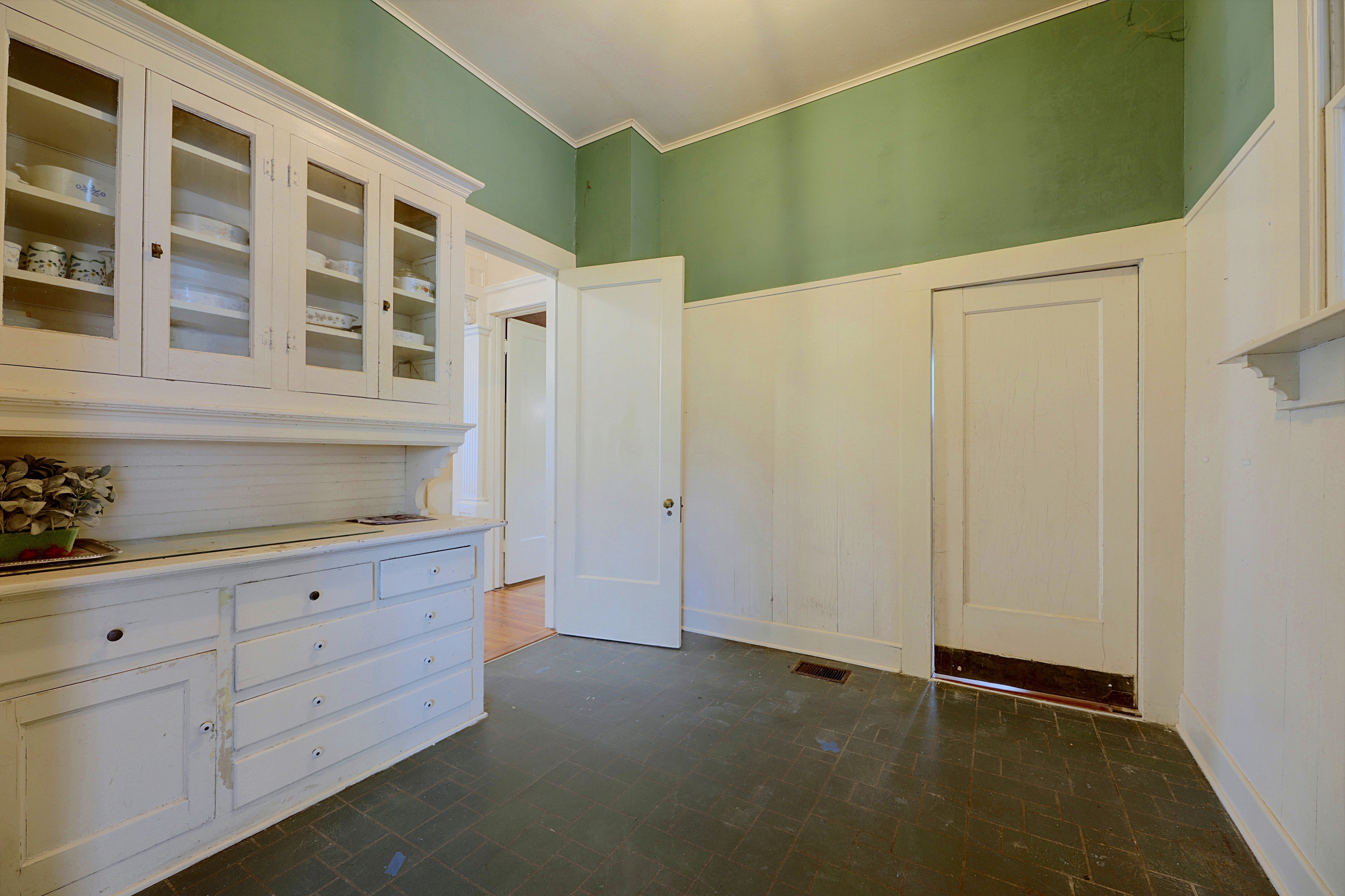 Butler's pantry featuring extensive white cabinetry and drawers for storage.