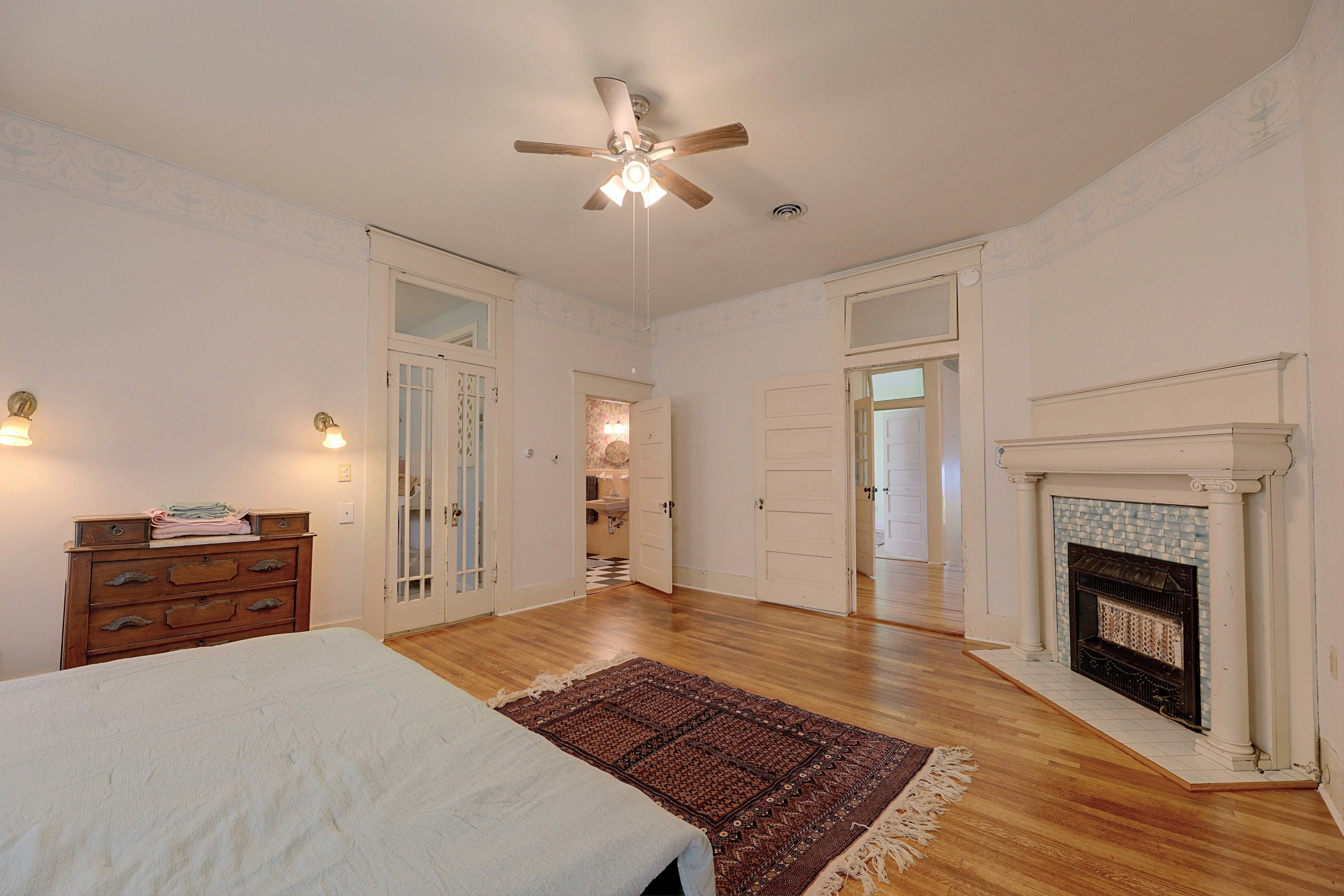 Fireplace feature in the primary bedroom with decorative tile surround.