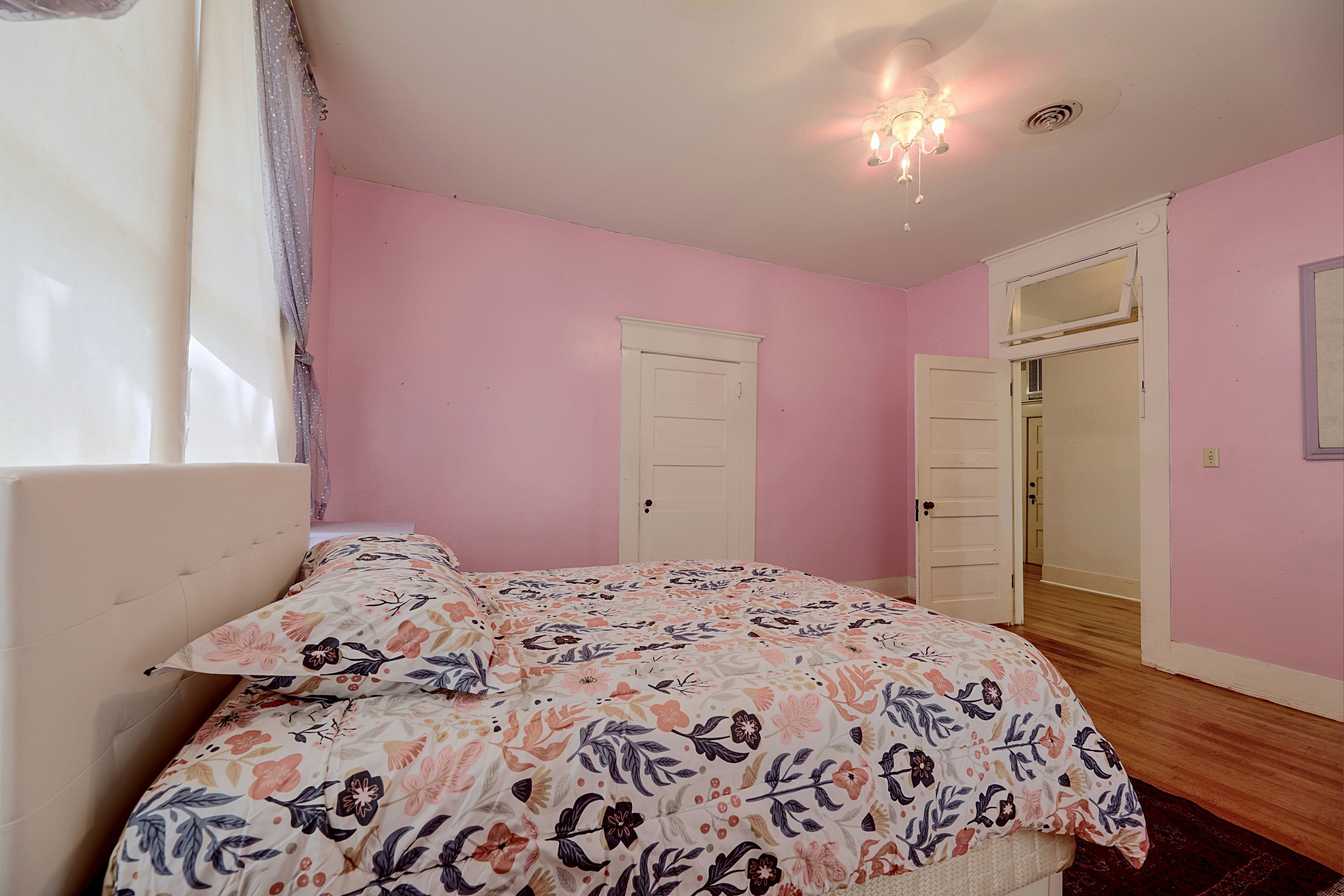 Close-up view of the bed setup in the pink bedroom.