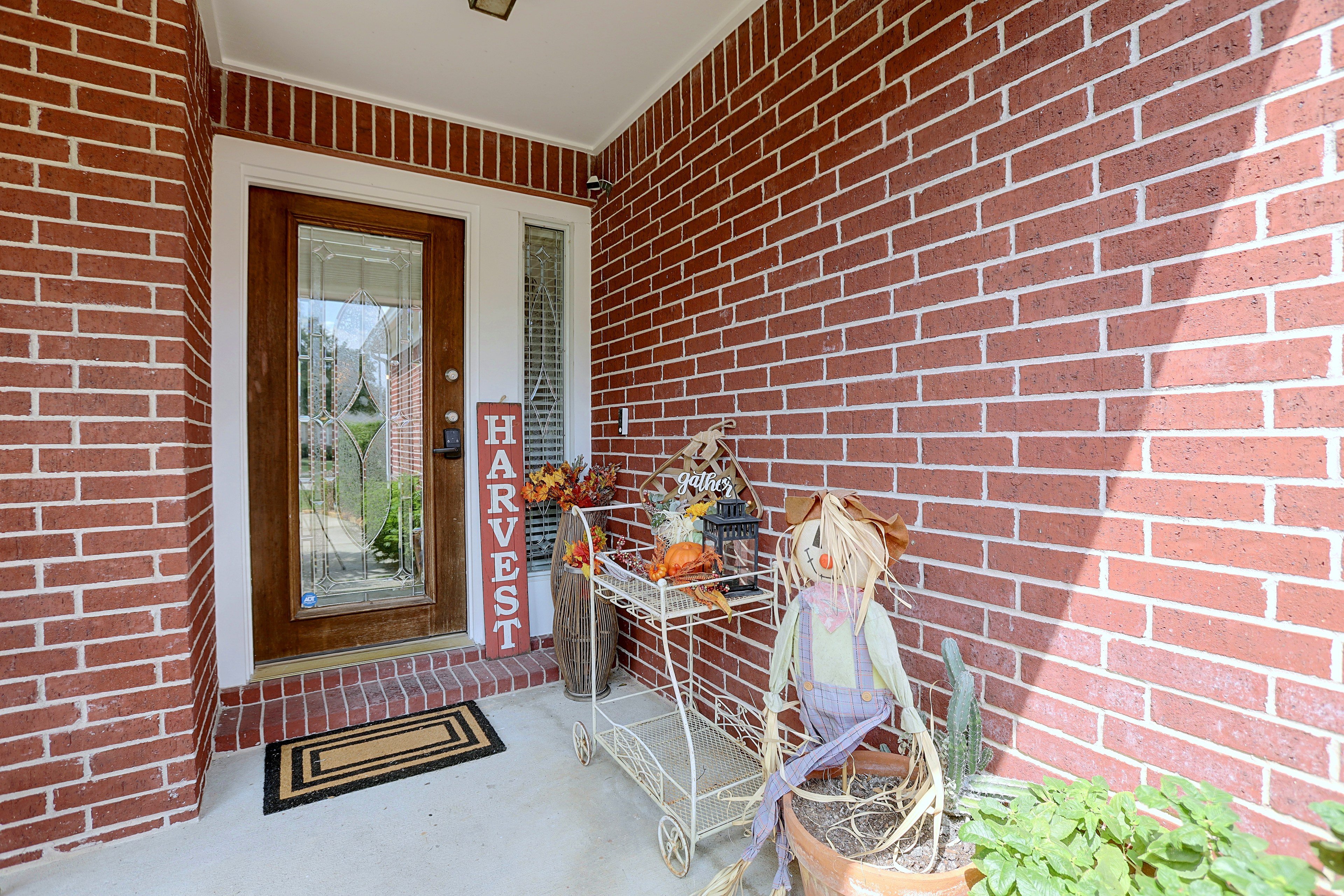 Front porch entryway decorated with seasonal fall decor.