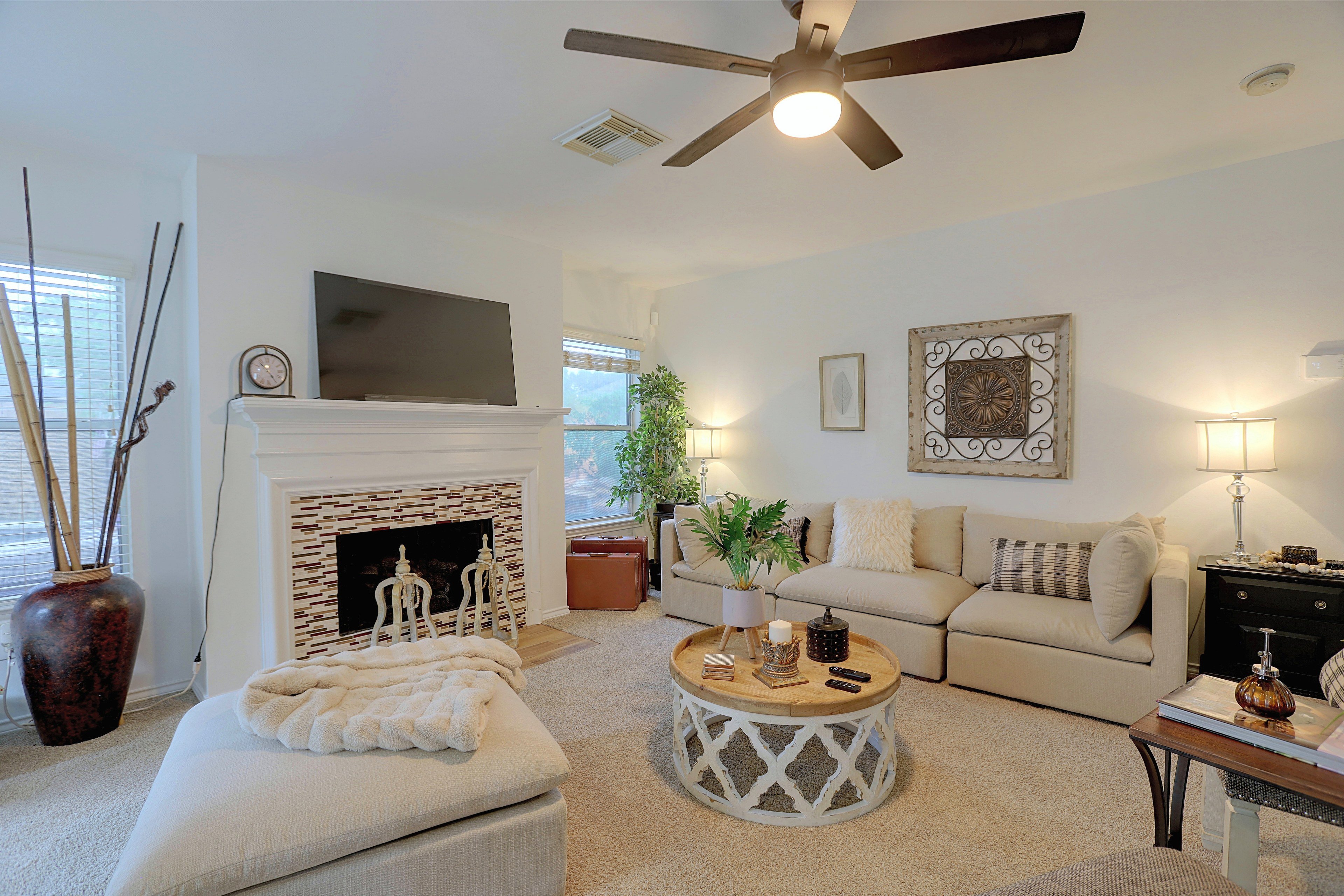 Living room seating area with neutral sofa and accent lighting.