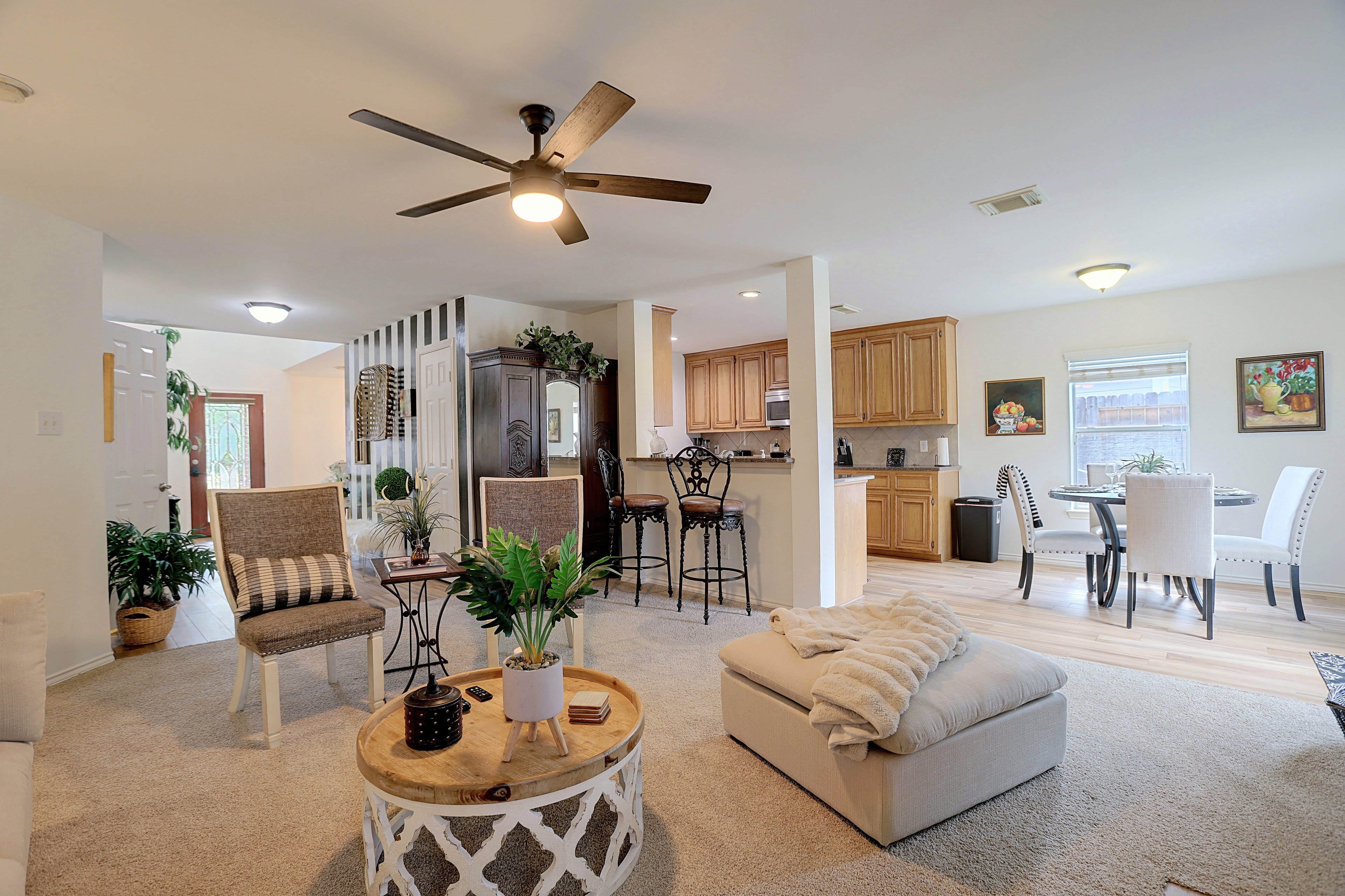 Open living area with view to kitchen bar and dining nook.