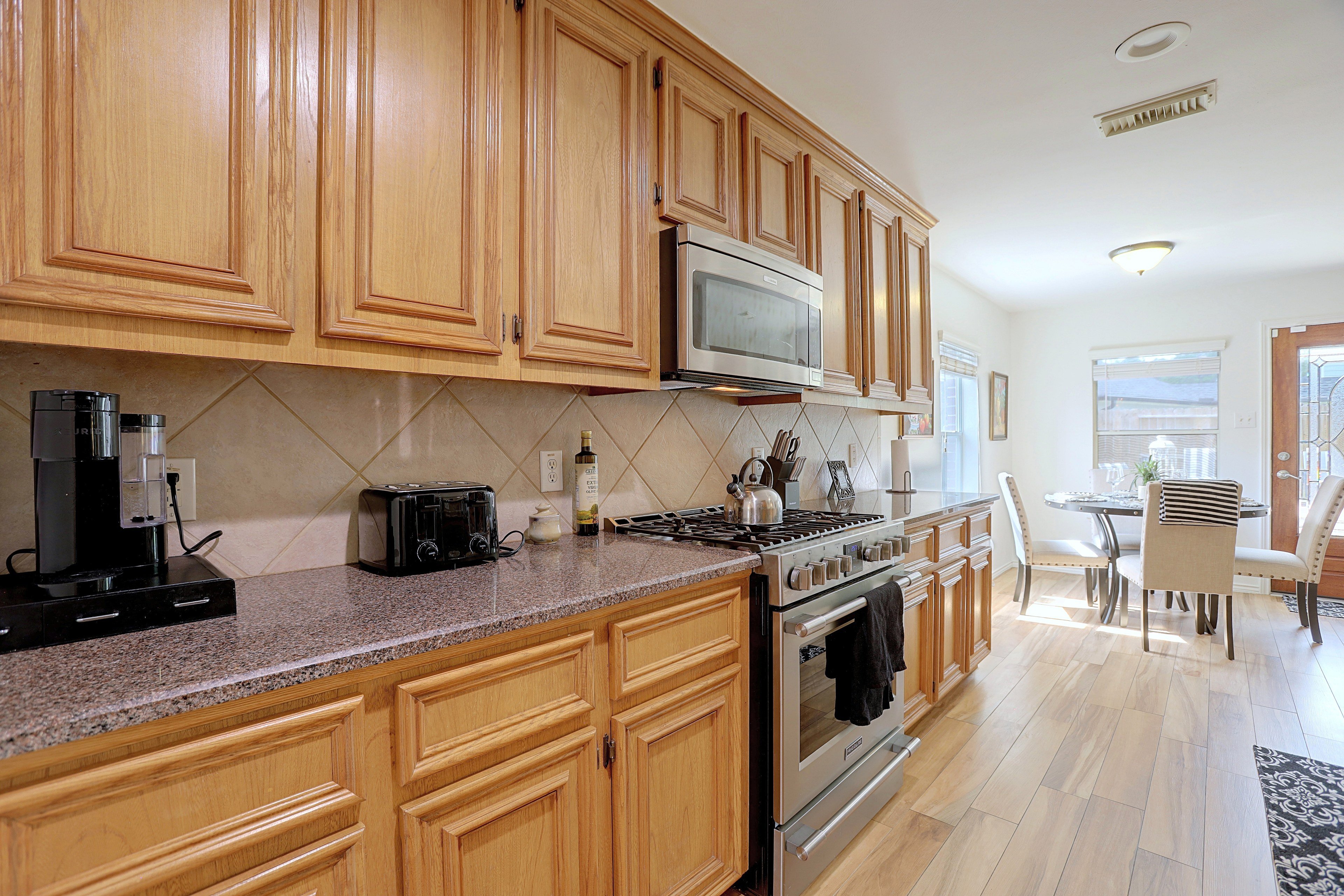Kitchen counter workspace with gas range and coffee maker.